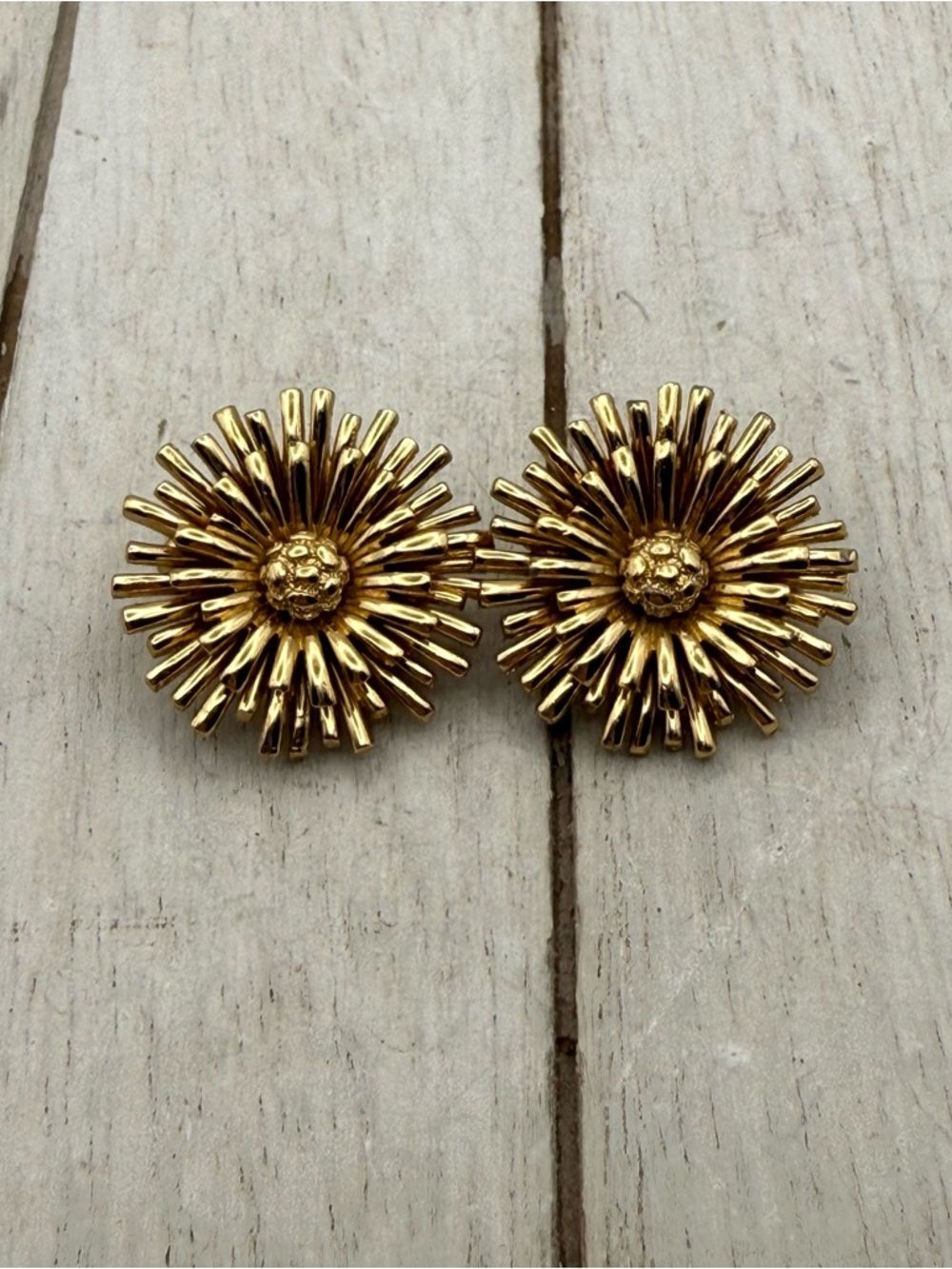 Vintage Monet gold tone starburst flower clip on earrings